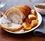 Pork loin on a plate with roast potatoes