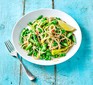 A bowl of asparagus and lemon spaghetti with peas