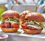 Buffalo chicken burgers with ranch slaw on a serving board