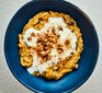 Butternut squash oats topped with yogurt and cinnamon in bowl