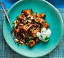 Butternut squash and mushroom curry with raita on plate with fork