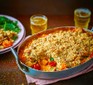 Butternut squash & cherry tomato crumble in a baking dish