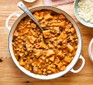 Cashew butternut squash curry served in a casserole dish