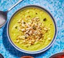 A bowl of cauliflower & broccoli soup with seedy crumble