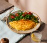 Cheese omelette on a plate with a green salad