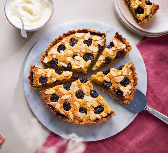 Sliced cherry bakewell tart, on a plate