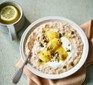 Cinnamon porridge in a bowl topped with baked bananas and seeds