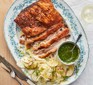 Crispy crackled pork belly with fennel & apple slaw served on a decorative plate