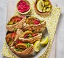 Falafels in pitta bread that has been grilled. With gherkins, pickled cabbage and greens