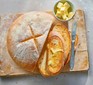 Classic white loaf on a board with butter