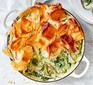 Herby spring chicken pot pie in a casserole dish