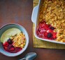 Gluten-free mixed berry crumble served with custard