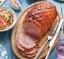 A carved gochujang & ginger beer glazed holiday ham