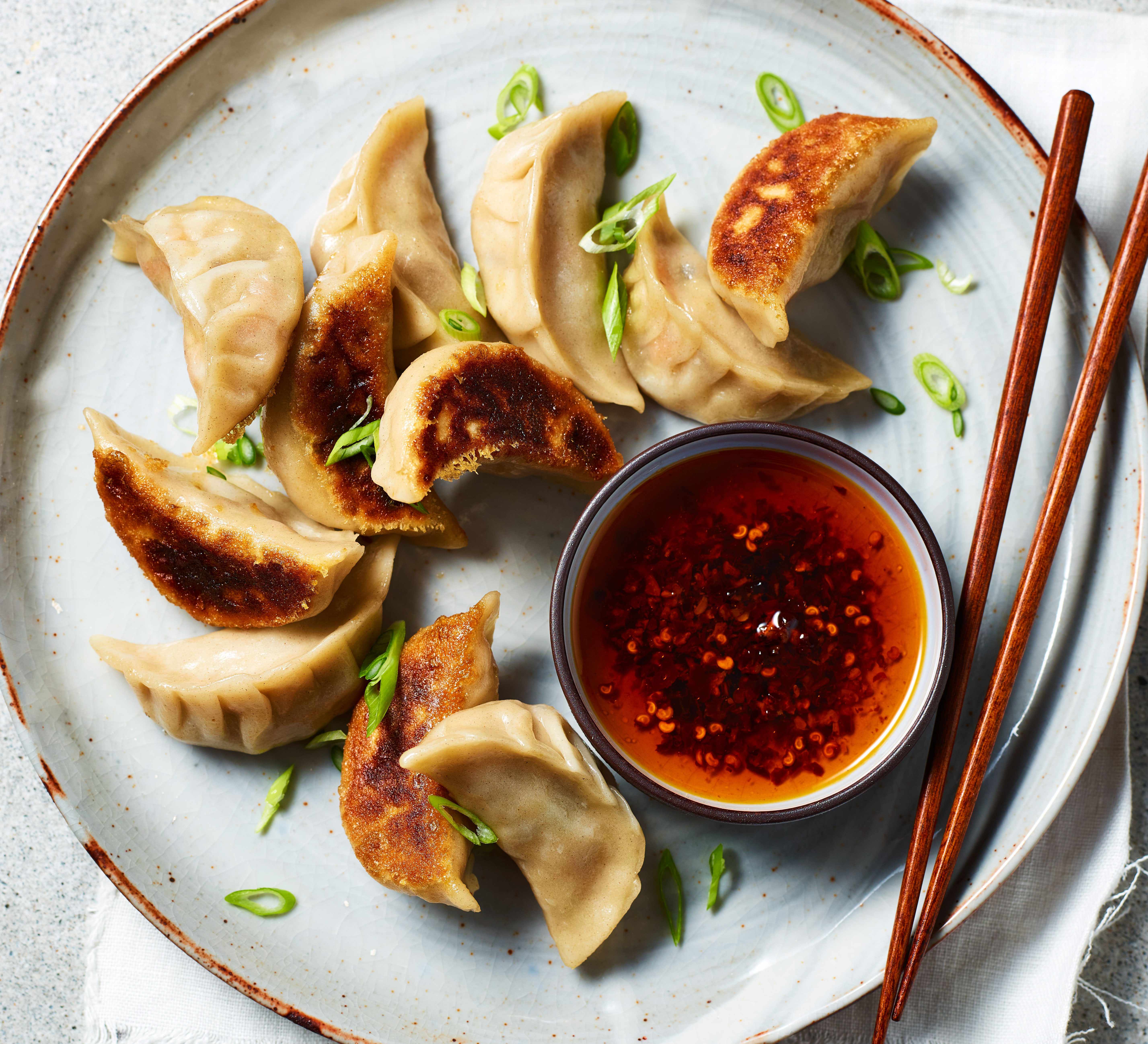 Gyoza on plate with sauce