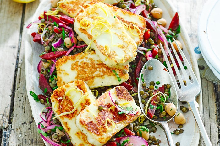 Platter of lentils, chickpeas and beetroot topped with halloumi slices