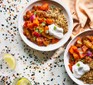 Two plates of harissa vegetables with quinoa