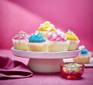 Iced fairy cakes on a cake stand