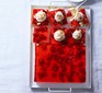 Jelly & custard trifle cut into squares in baking tin