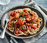 A plate serving slow cooker meatballs with spaghetti