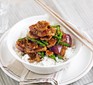 Pork, green bean and oyster stir fry in a bowl on top of rice