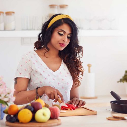 Woman chopping vegetables in kitchen