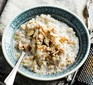 A bowl of slow cooker rice pudding with almonds flaked on top